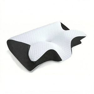 Black cervical memory foam pillow on neutral linen bedding