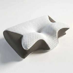 Light grey cervical memory foam pillow on linen bedding