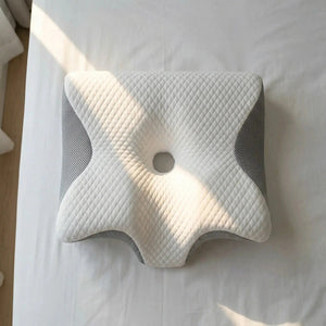 Cervical memory foam pillow with shoulder cutout, three-quarter view