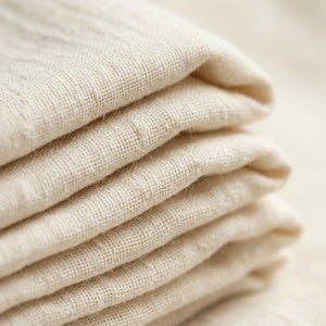 Close-up texture of 100% cotton muslin weave — Livnorr throw blanket fabric detail