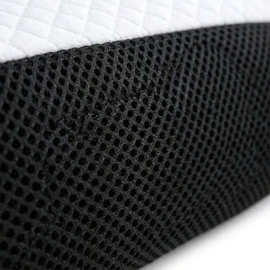 Cervical pillow centred on a white duvet