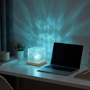 Aurora wave lamp on minimal desk beside laptop