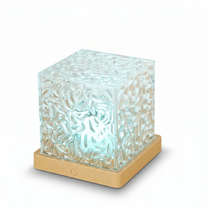 Aurora Wave Projection Lamp – clear acrylic cube on gold base, studio shot