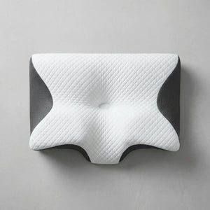 Light grey cervical pillow flatlay on a linen sheet