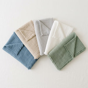 Livnorr muslin throw blanket color variants flat lay — blue beige grey white sage