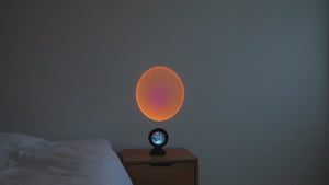 Cinematic pan across Scandinavian bedroom with sunset projection light filling the wall