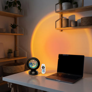 Sunset Projection Light on desk beside MacBook, warm amber focus atmosphere