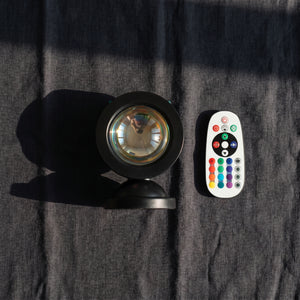 Sunset Projection Light and remote control flat lay on dark linen