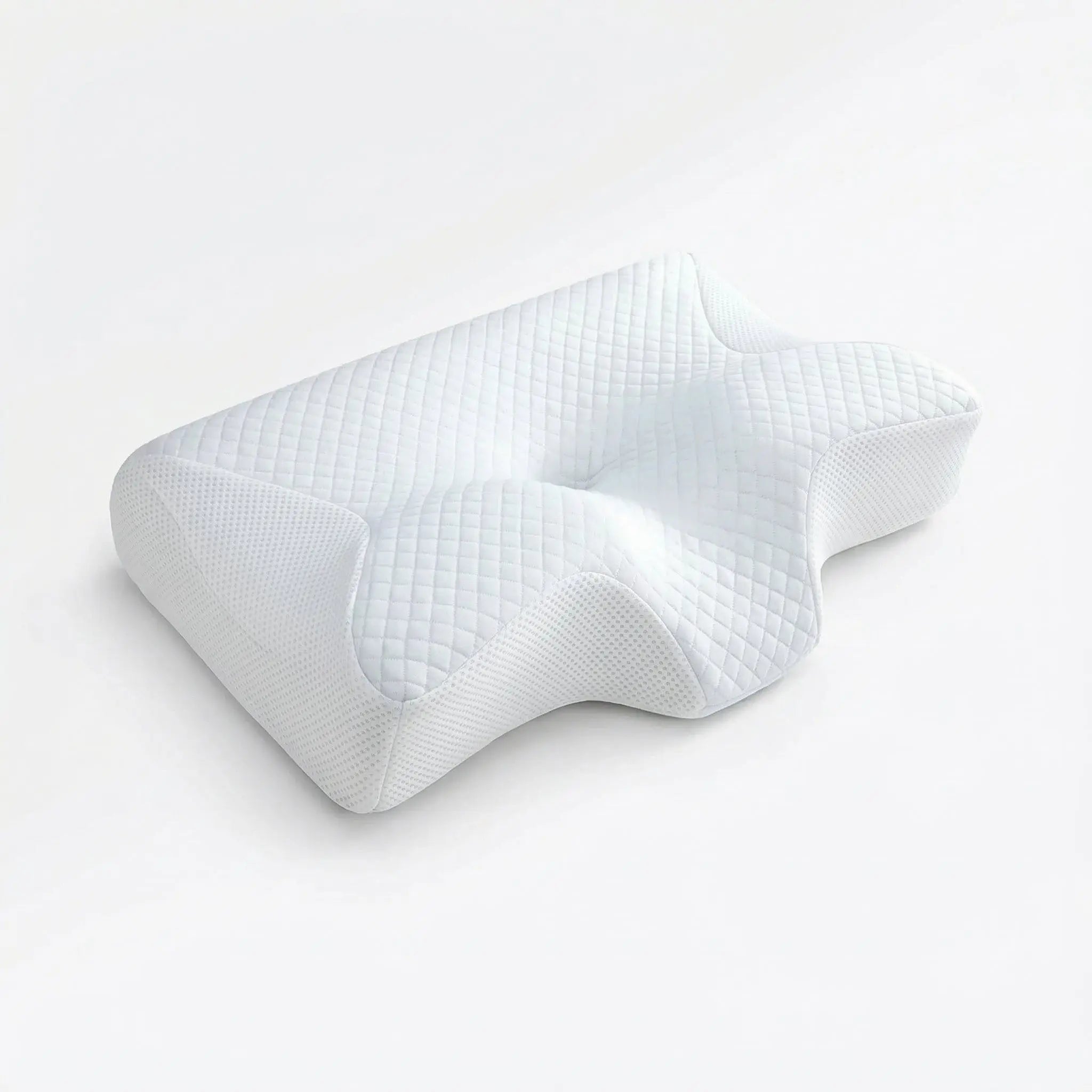 White cervical memory foam pillow on a minimal bedroom backdrop