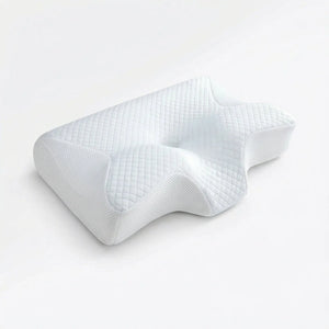 White cervical memory foam pillow on a minimal bedroom backdrop