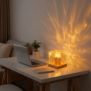 Water ripple lamp on minimal desk beside laptop