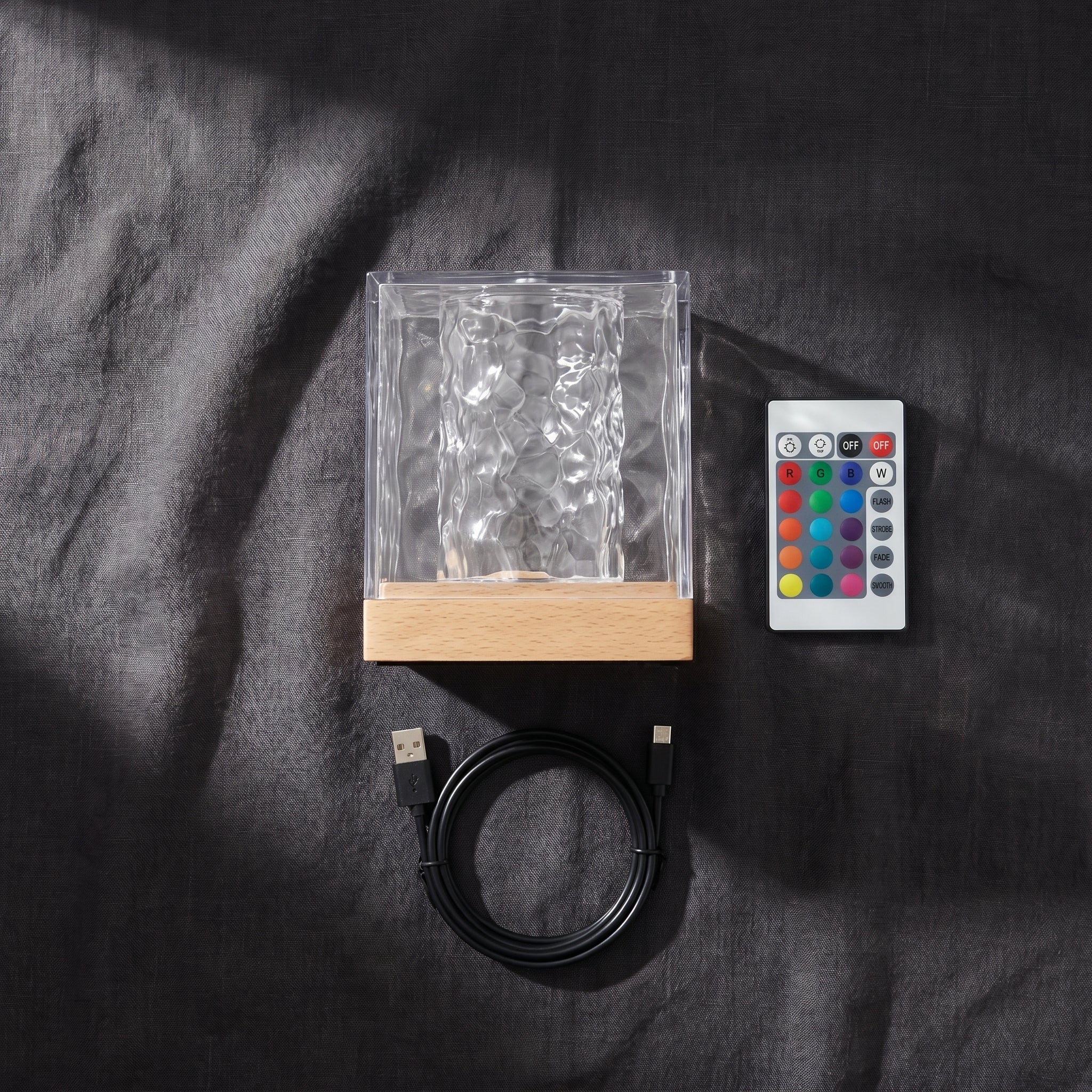 Water ripple lamp with remote control and USB cable flat lay