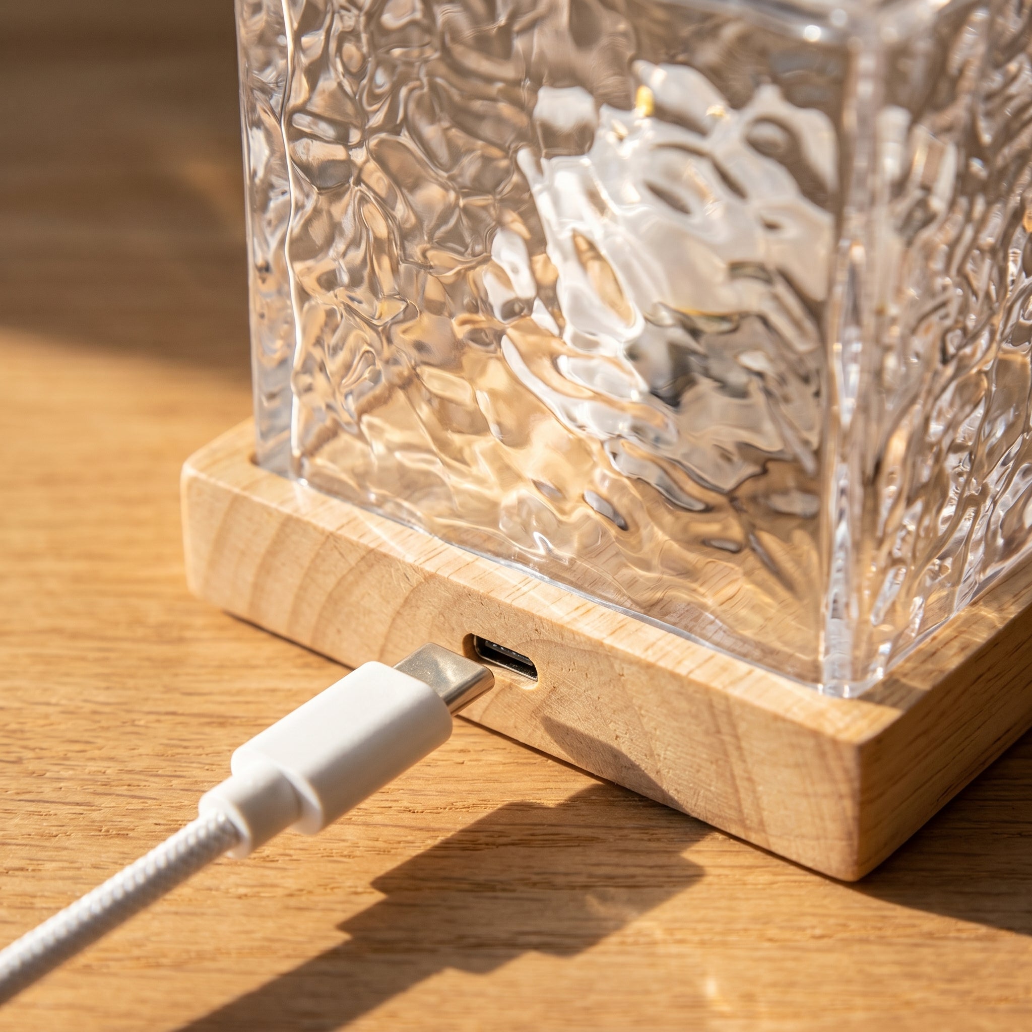 USB port detail on wooden base of water ripple lamp
